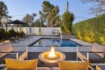 Comfortable seating around the fire-pit with nice poolside views